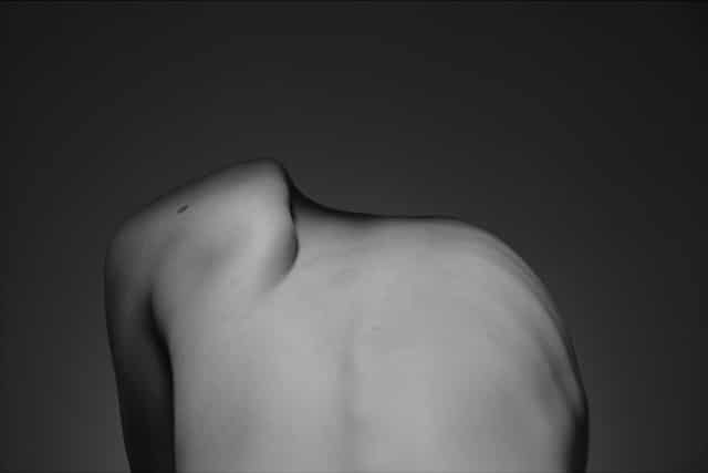 Artistic black and white image of human back and shoulder showing body awareness and somatic experience in therapy