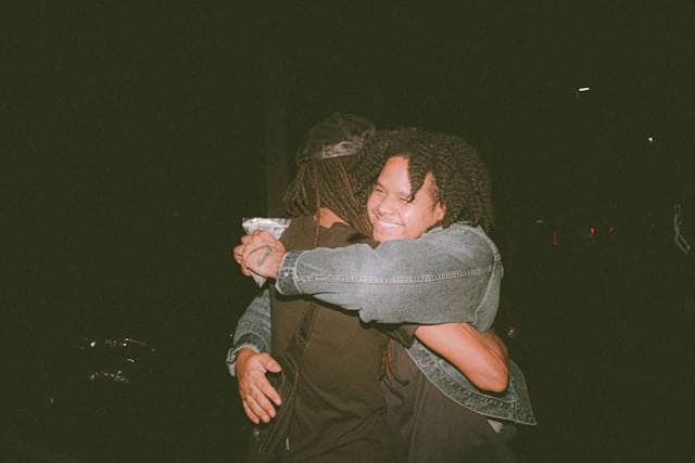 Two people embracing closely in the dark showing vulnerable emotional intimacy and secure attachment in relationships