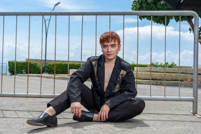 Person sitting grounded outdoors with calm present expression representing mindfulness therapy in California