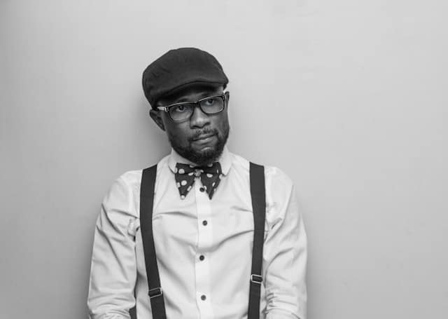 Man with glasses in thoughtful contemplation representing self reflection in San Francisco mindfulness based therapy